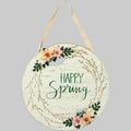 Round wooden sign with 'Happy Spring' text and floral decorations on a white background